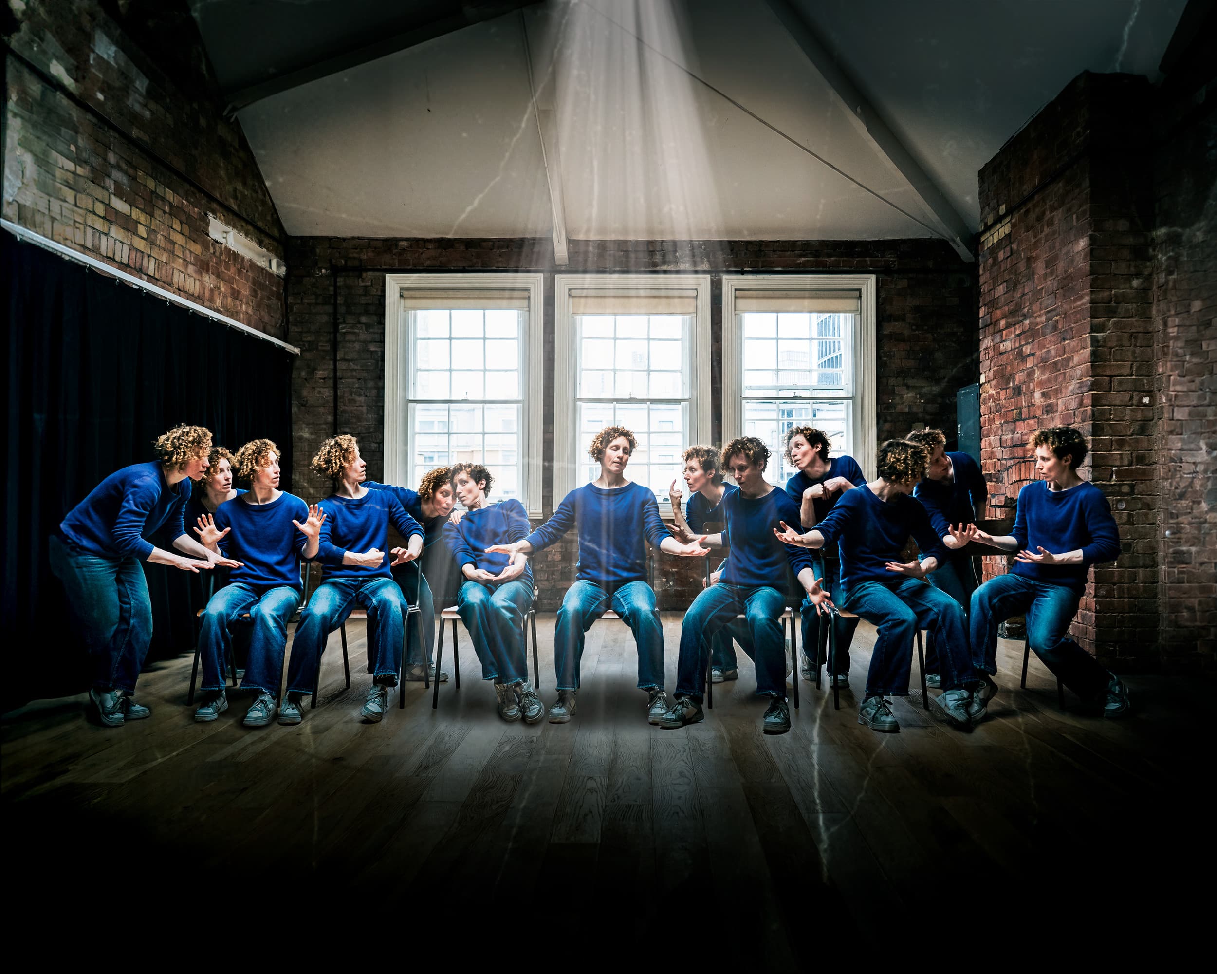 Nikki wearing jeans and a blue jumper posing as all of the characters of the last supper by Leonardo Da Vinci